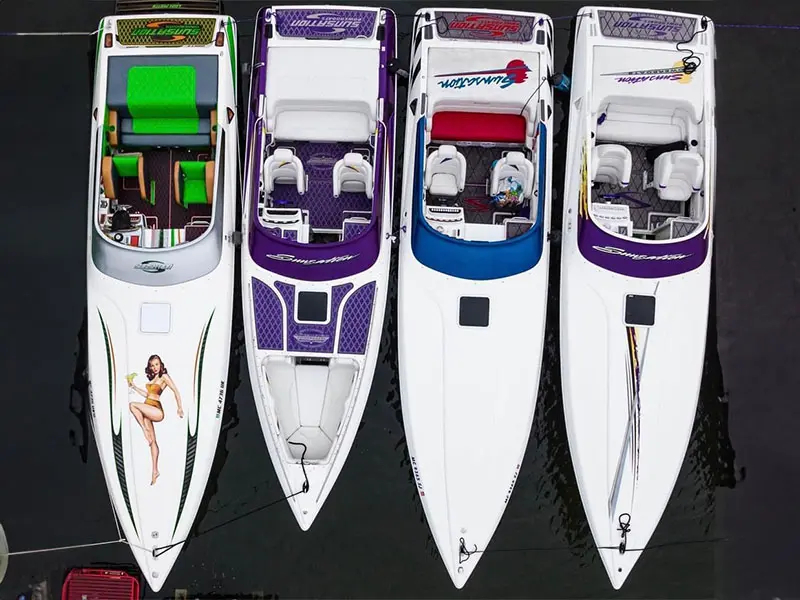 Four boats are lined up in a row.